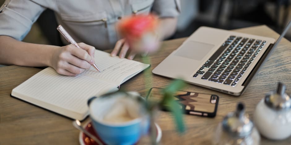 Person researching and taking notes about affiliate marketing and what it is